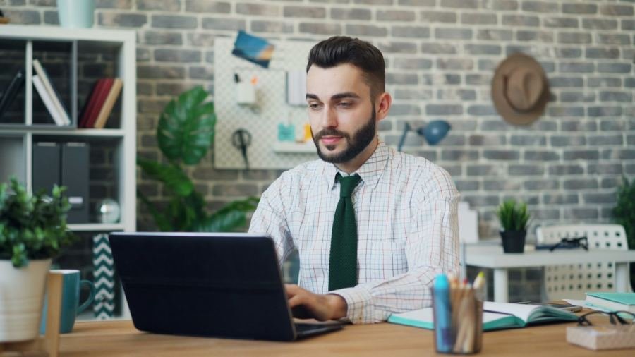A candidate working on a laptop at his desk